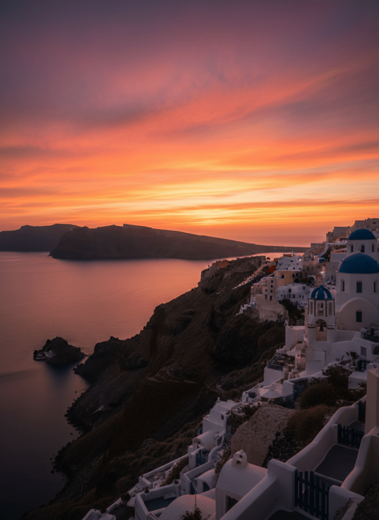 Breathtaking Santorini sunset over the caldera, fiery orange and magenta sky reflected on the Aegean Sea, silhouettes of whitewashed domed buildings and church bell towers on the cliff edge, dramatic volcanic landscape, long exposure photography feel, warm golden light, photographic realism, professional travel photography, portrait orientation
